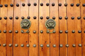 wooden door knocker on metal