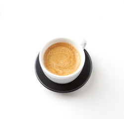 Cup of coffee on white paper background. Close up. Copy space.