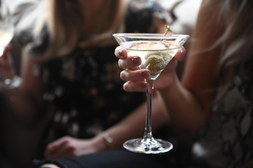 Close up of woman holding cocktail drink