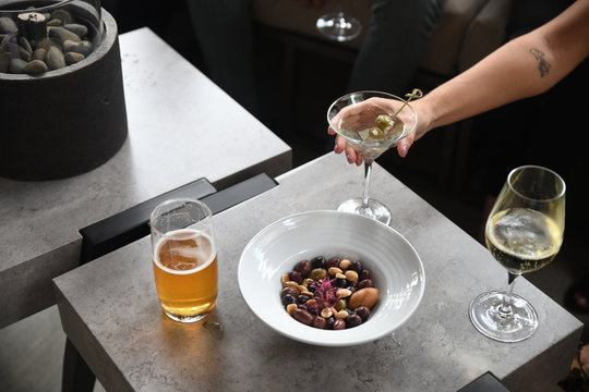 Woman's hand picking up drink at table