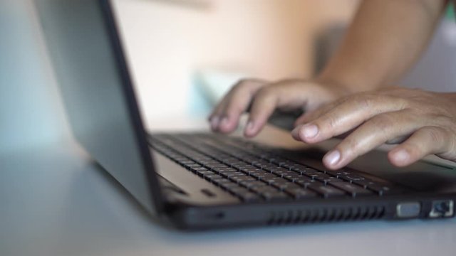 Black hands of anonymous hackers  typing code on keyboard of laptop for remotely reach, receiving personal information online, Networking Crime Payment Security Concept