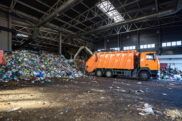 truck throws garbage at sorting modern waste recycling processing plant. Separate and sorting...