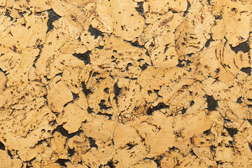 Close-up of cork sound insulation lagging with interspersing of black paint floors and walls