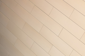 Matte beige color tiled wall of building