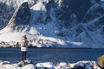 girl walks along the shore of the fjord