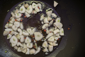 chinese cuisine - garlic frying on the pan