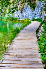Wooden pathway and clear water in National Park Plitvice Lakes in autumn, Croatia