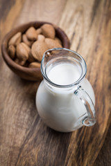 Obraz na płótnie Canvas Jar of almond milk with almond nuts