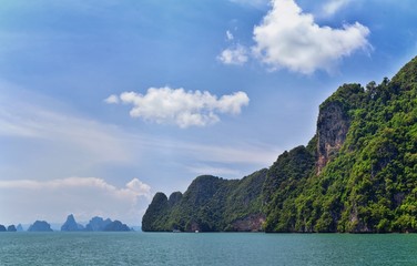 Island, Ocean views near Phuket Thailand with Blues, Turquoise and Greens oceans, mountains, boats, caves, trees resort island of phuket Thailand. Including Phi Phi, Ko Rang Yai, Ko Li Pe and other is