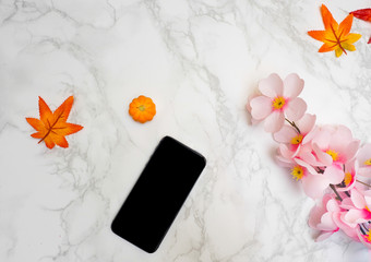 Chocolate homemade and flower with smartphone on marble backgrou