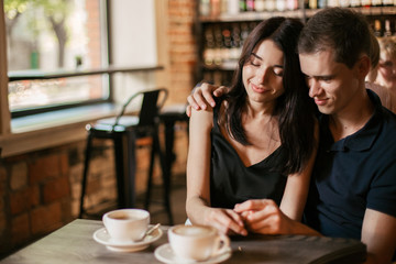 Loving couple hugging in the cafe.