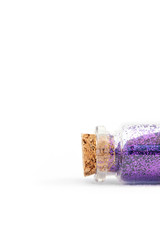 Single tube of purple glitter displayed on white background - tube in horizontal position
