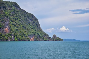 Island, Ocean views near Phuket Thailand with Blues, Turquoise and Greens oceans, mountains, boats, caves, trees resort island of phuket Thailand. Including Phi Phi, Ko Rang Yai, Ko Li Pe and other is