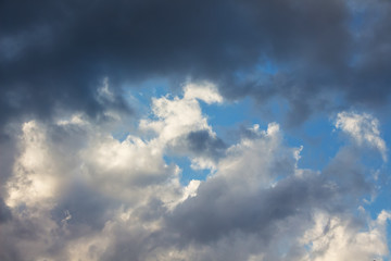 Naklejka na ściany i meble Dark storm clouds in blue sky, background for design_