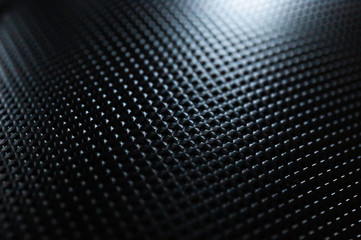 Close Up of Light Bouncing Off a Black Textured Notebook Cover - obrazy, fototapety, plakaty
