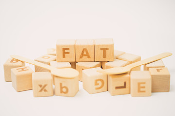 Fototapeta premium FAT word on wooden cube and stethoscope.