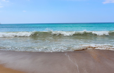 view of patong beach in phuket, sea waves roll on the sandy shore, foam and spray of water