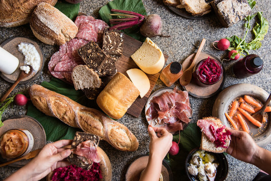 three hands holding food