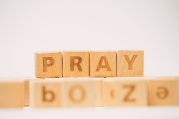 PRAY word on wooden block.Concept for faith,spirituality and religion.