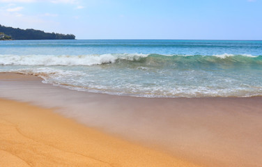 Fototapeta na wymiar view of patong beach in phuket, sea waves roll on the sandy shore, foam and spray of water