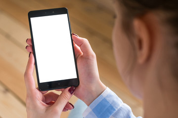 Mockup image: woman looking at black smartphone with white blank screen. Close up view of woman hands with smart phone mobile device. Mock up, copyspace, template and technology concept