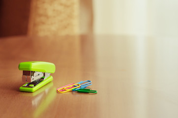 Green stapler and paper clip