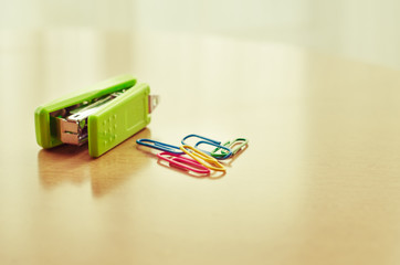 Green stapler and paper clip