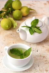 Mint tea in the cup near teapot 