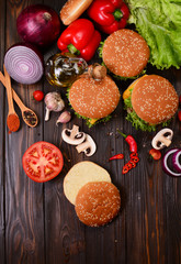 Hamburgers of the best products on a wooden background