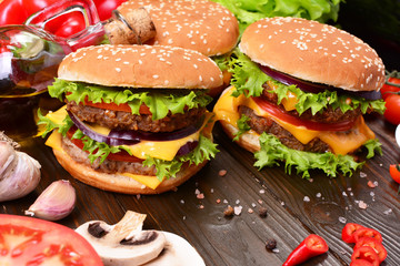 Hamburgers of the best products on a wooden background