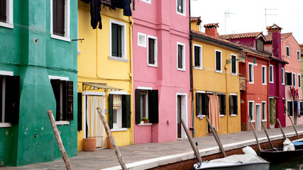 Fototapeta na wymiar Colorful houses next to a canal in Burano, island next to Venice, Italy. 
