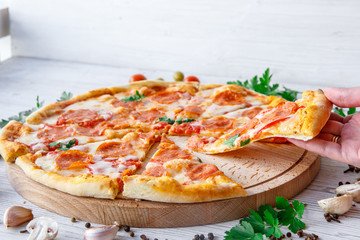 Italian pizza pepperoni on a light wooden background