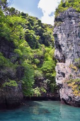 Island, Ocean views near Phuket Thailand with Blues, Turquoise and Greens oceans, mountains, boats, caves, trees resort island of phuket Thailand. Including Phi Phi, Ko Rang Yai, Ko Li Pe and other is