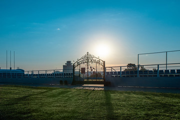 Gate to Youth Stadium early morning  with sunlight. Inscription on the gate: Youth