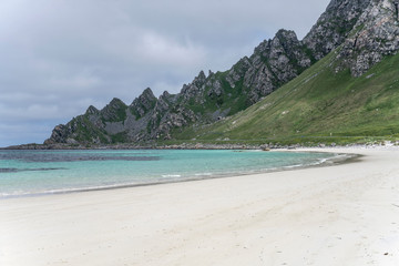 Fototapeta na wymiar inlet with clear water, white sand beach and steep rocks, Bleik , Norway