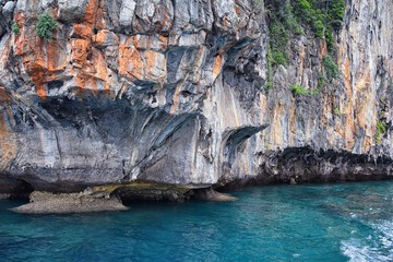 Island, Ocean views near Phuket Thailand with Blues, Turquoise and Greens oceans, mountains, boats, caves, trees resort island of phuket Thailand. Including Phi Phi, Ko Rang Yai, Ko Li Pe and other is