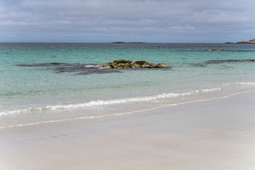 Fototapeta na wymiar small clear water waves on white sand beach, Bleik , Norway