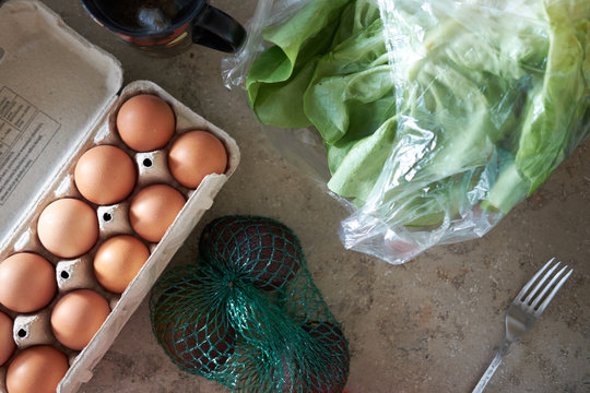 Breakfast ingredients of avicado, salad and eggs from above