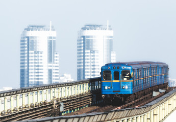 subway cars against the background of office skyscrapers