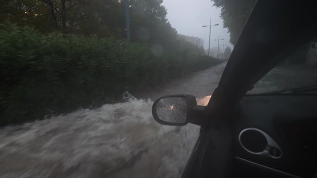 Car driving on a flooded street view from driver seat Montpellier heavy rainy day cloudy Antigone 