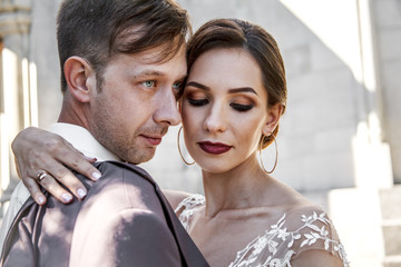 Portreit of wedding couple hugging on the romantic old city. Bride wearing elegant wedding dress
