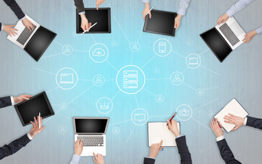 Group of people with devices in hands working in team on tablets, laptops with office, connection,...