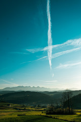 Landscape with blue sky and clouds in the mountains in evening time