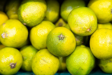Lime citrus fruits at fruit market, farmer's market, front view, close-up