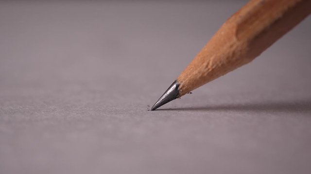 Slow-motion of Macro shot of pencil broken while writing