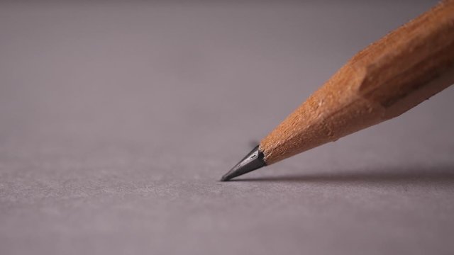 Slow-motion of Macro shot of pencil broken while writing