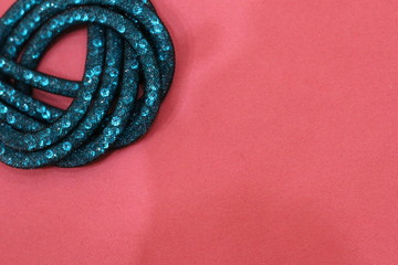 turquoise crystals in a grid on a pink background