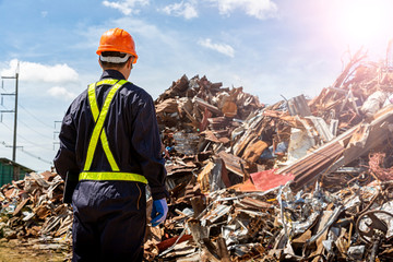The engineers in the recycling plant that are carrying the tablet. Looking for recycled materials...
