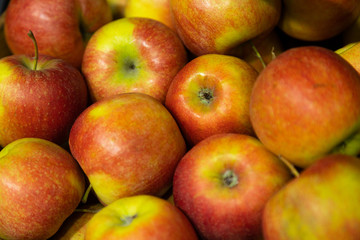 Closeup of fresh red-green apples on supermarket counter