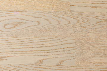 Flatlay of birch laminate floor covering of flaxen color